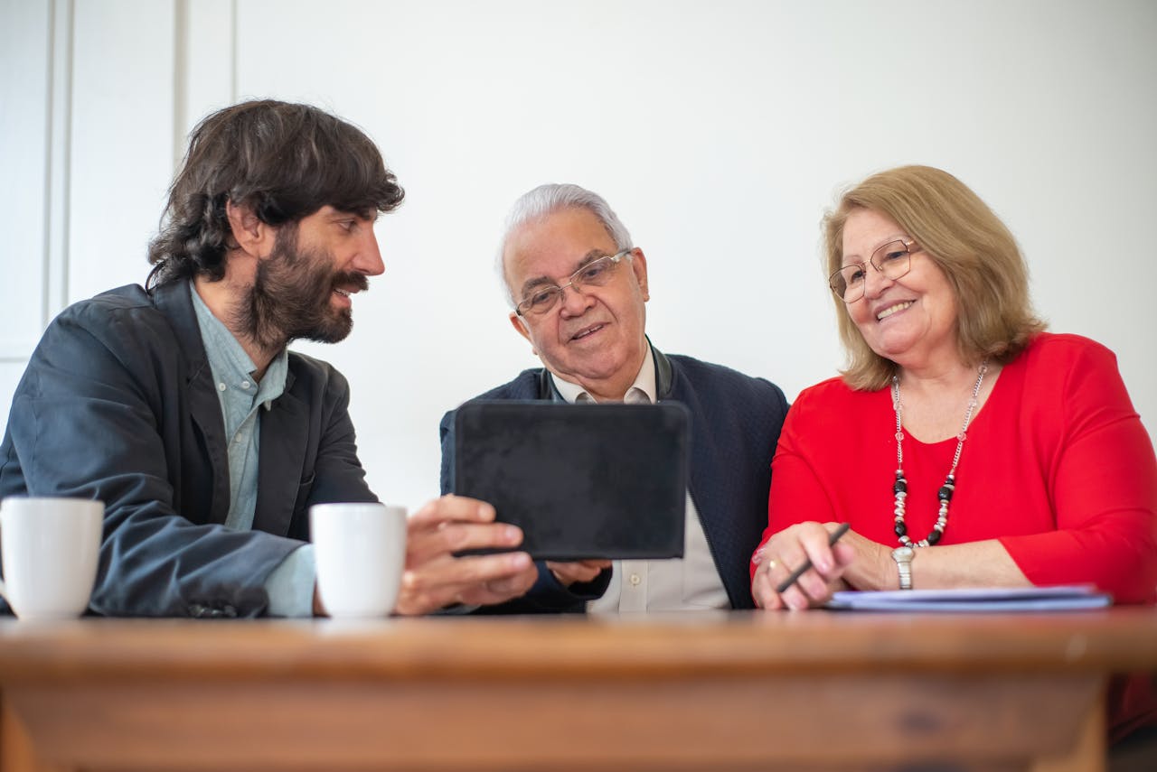 Elderly couple in a meeting with consultant, exploring financial or insurance options.